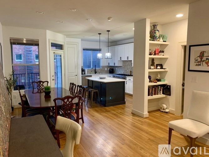 A kitchen with a dining table and chairs is available for rent.