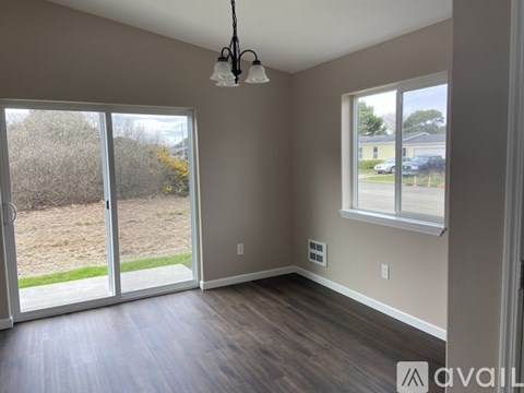 A room with a sliding glass door leading to a backyard.