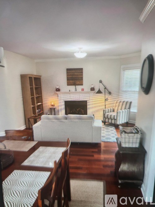 A living room with a fireplace and a white couch.