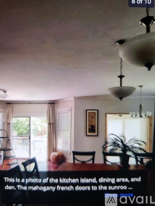 A photo of a kitchen island, dining area, and den with a view of the sunroof.