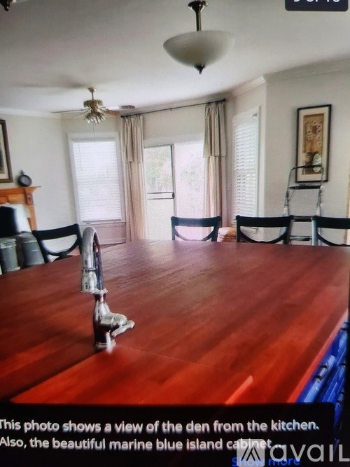 A dining room with a wooden table and chairs.