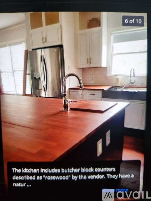 A kitchen with a wooden countertop and butcher block counters.