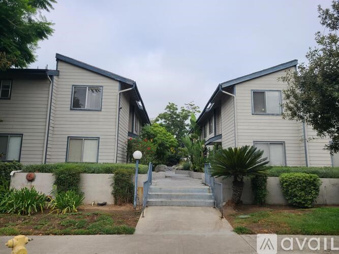 A row of houses with a fire hydrant in front of them.
