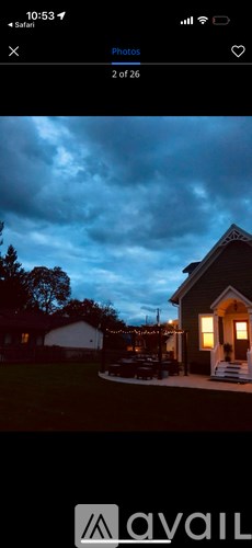 A house with lights on is shown in the image.