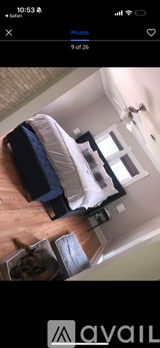 A bedroom with a bed and a window.