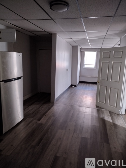 A kitchen with white cabinets and a black stove top.