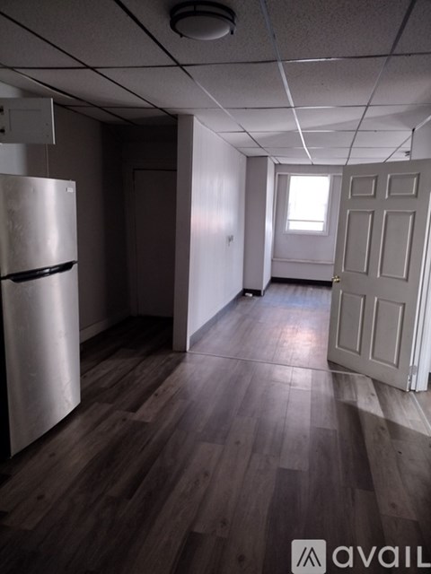 A kitchen with white cabinets and a black stove top.
