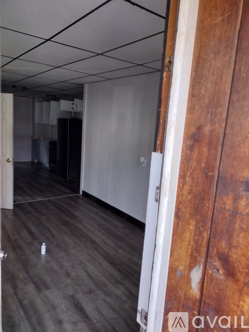A dark hallway with a door on the right.