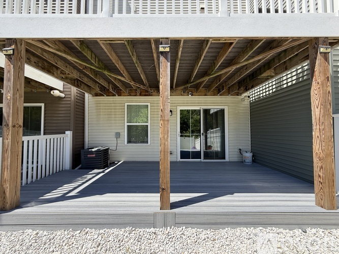 A house with a grey exterior and a wooden porch.