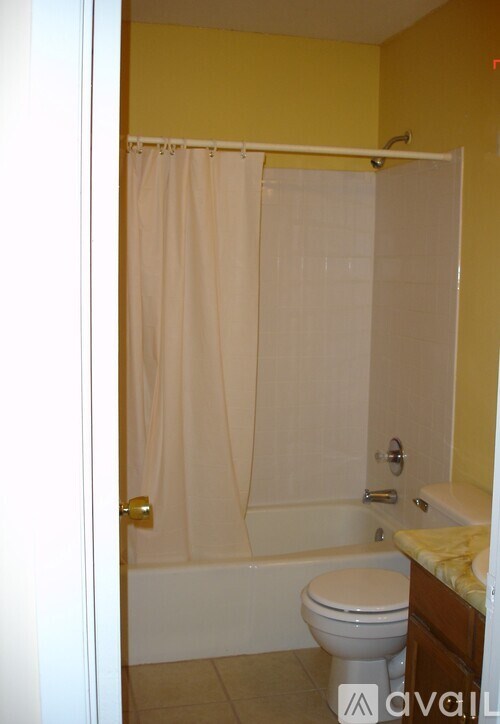 A bathroom with a toilet, tub, and sink.