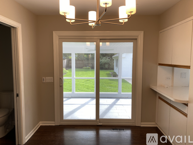 A room with a sliding glass door leading to a backyard.