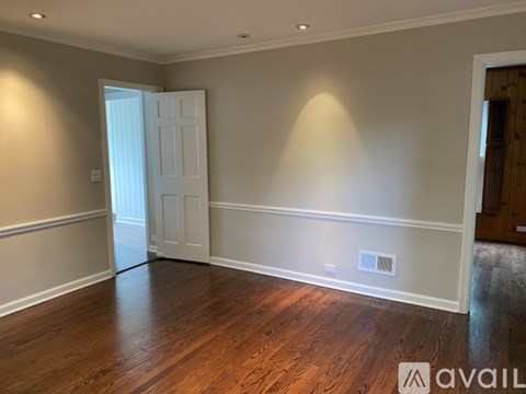 A room with wooden floors and a white door.