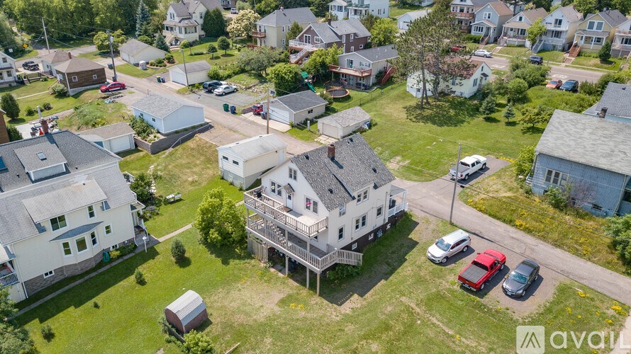 A bird's eye view of a neighborhood with houses and cars.