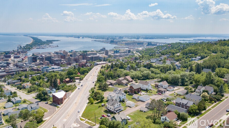 A bird's eye view of a residential area with a road running through it.