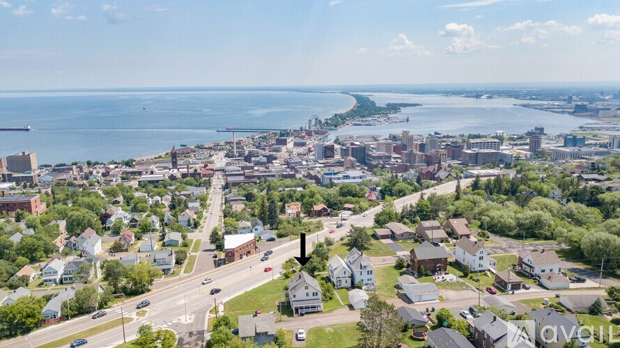 A bird's eye view of a residential area with a road running through it.