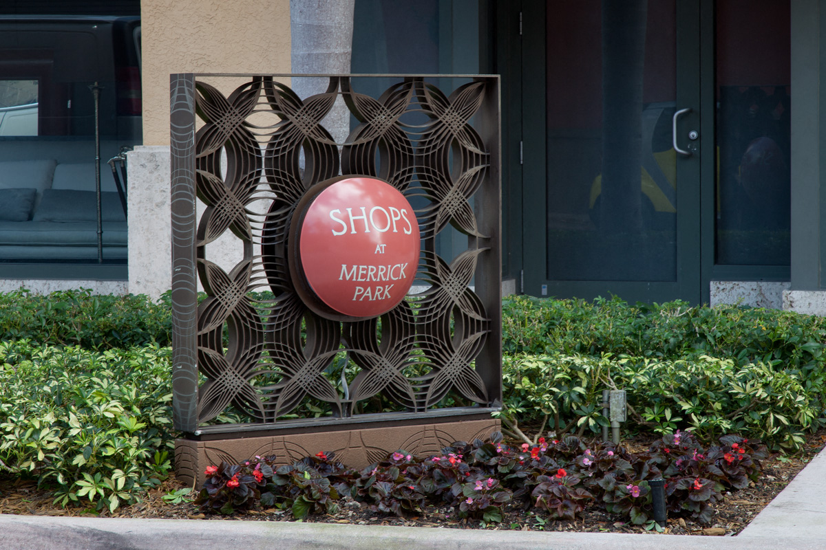 a red sign that reads show a mercedes benz park in front of a building