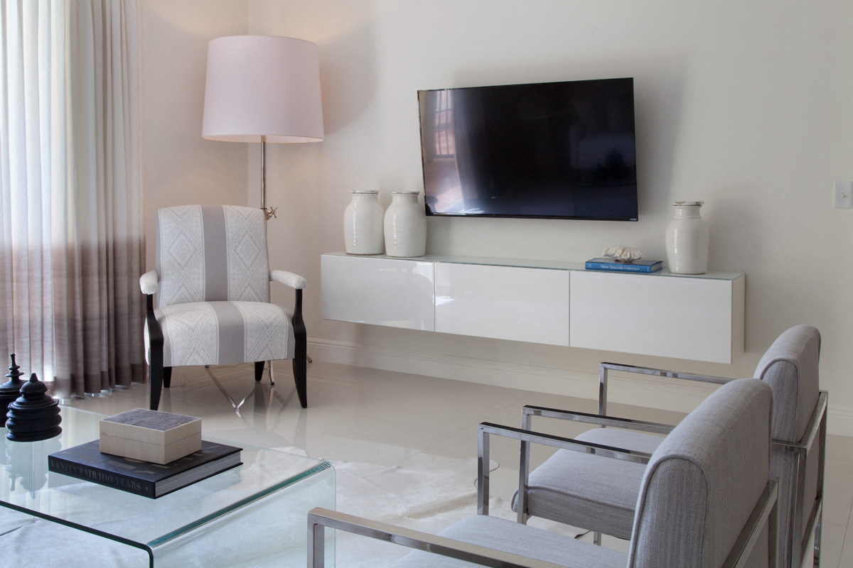 a living room with a television and a table and chairs