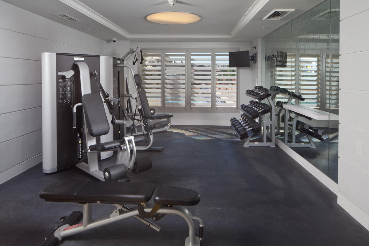 a gym with exercise machines and a large window