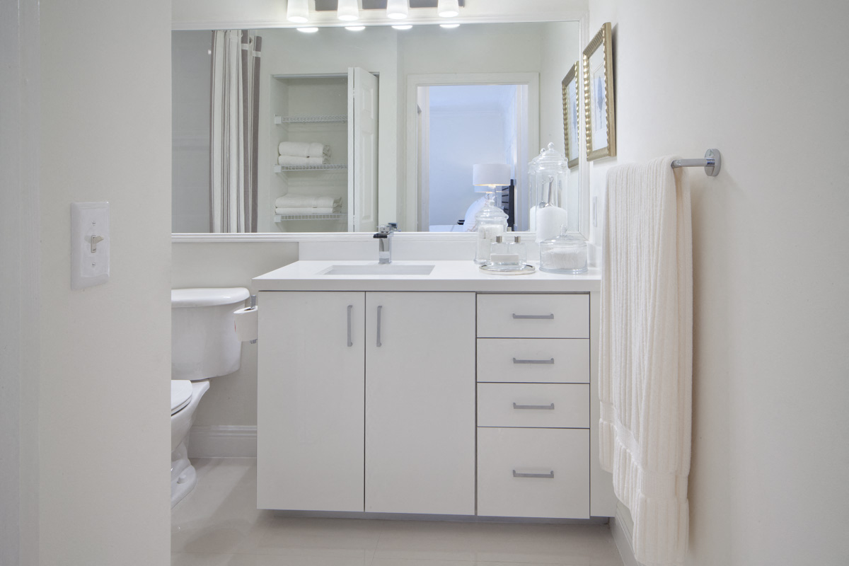 a white bathroom with a sink and a mirror