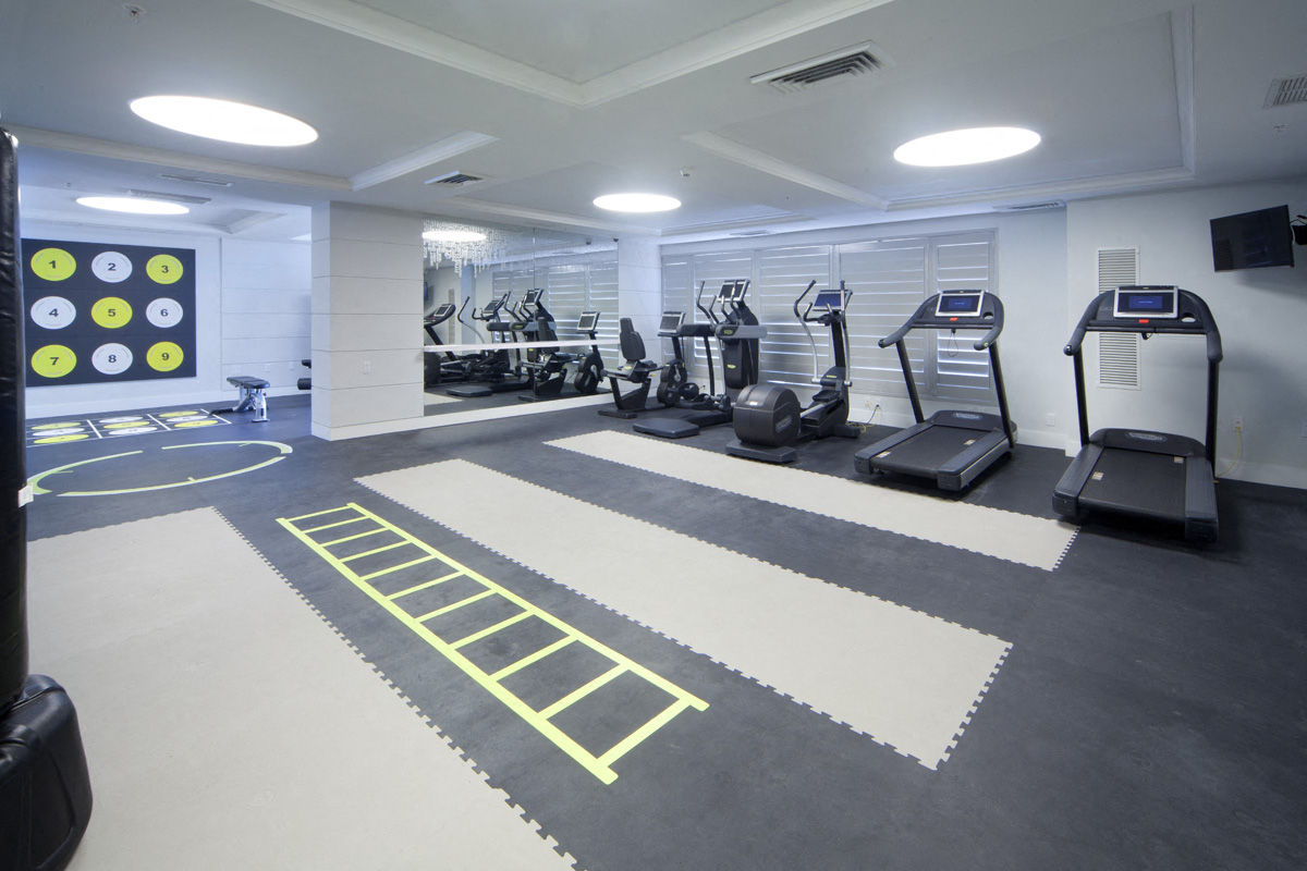 a gym with treadmills and other exercise equipment in a building