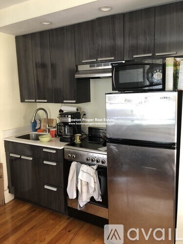 A kitchen with a stove top oven and a microwave.