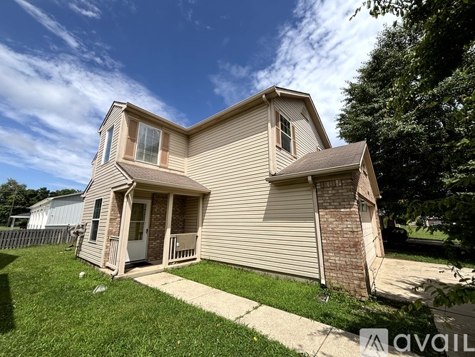 A two-story house with a front porch and a garage.