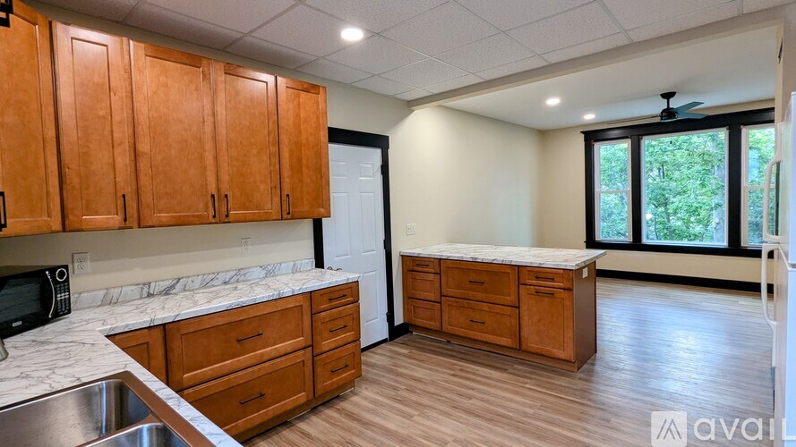 A kitchen with wooden cabinets and a white countertop.