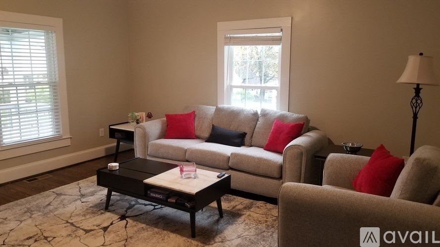 A living room with a couch, chair, and coffee table.