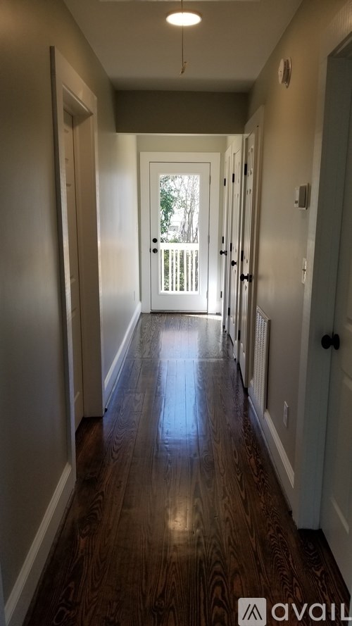A long hallway with a door at the end.