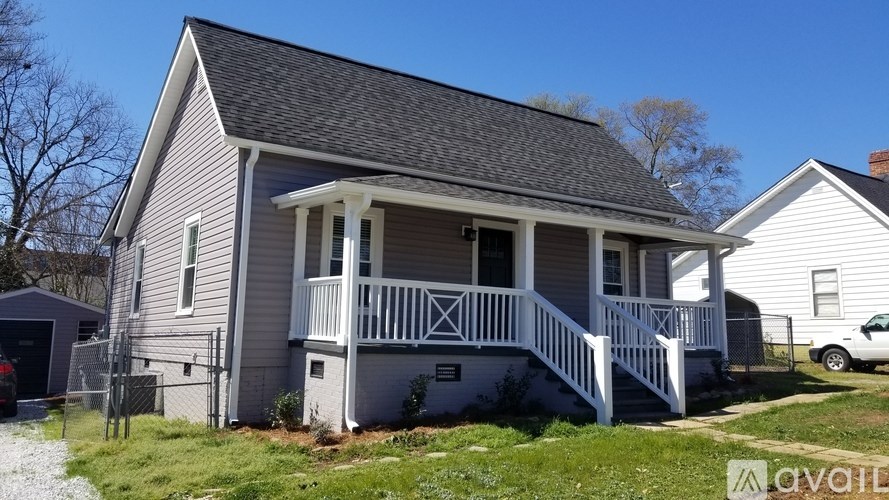 A two-story house with a front porch and a garage.