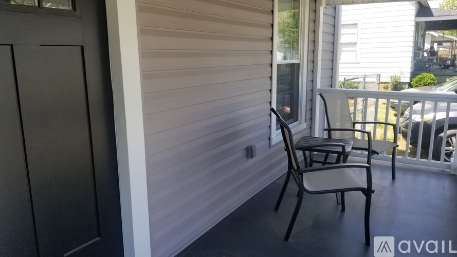 A patio with a chair and a table.