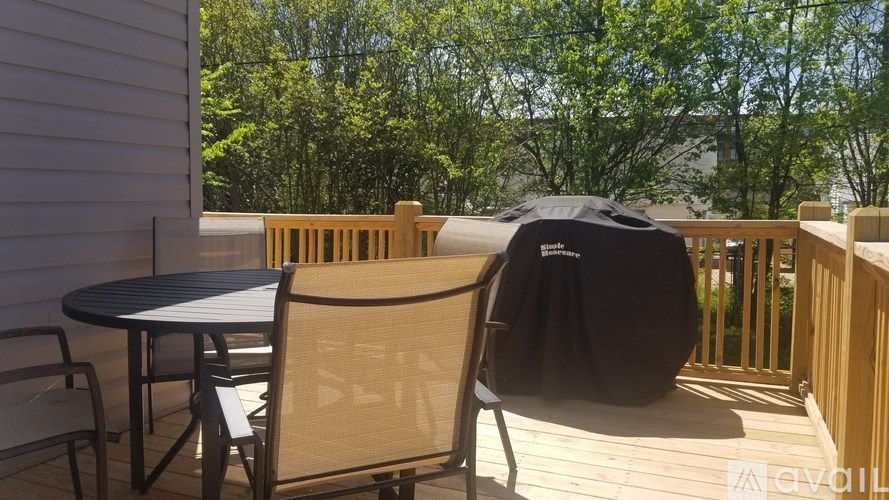 A patio with a table, chairs, and an umbrella.