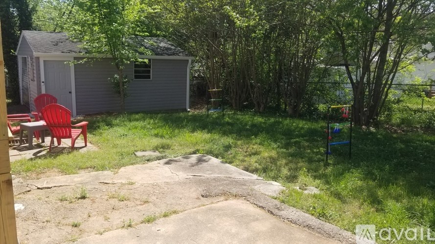 A backyard with a concrete slab and a shed.