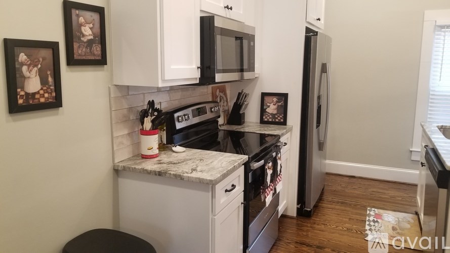A kitchen with a stove, microwave, and refrigerator.