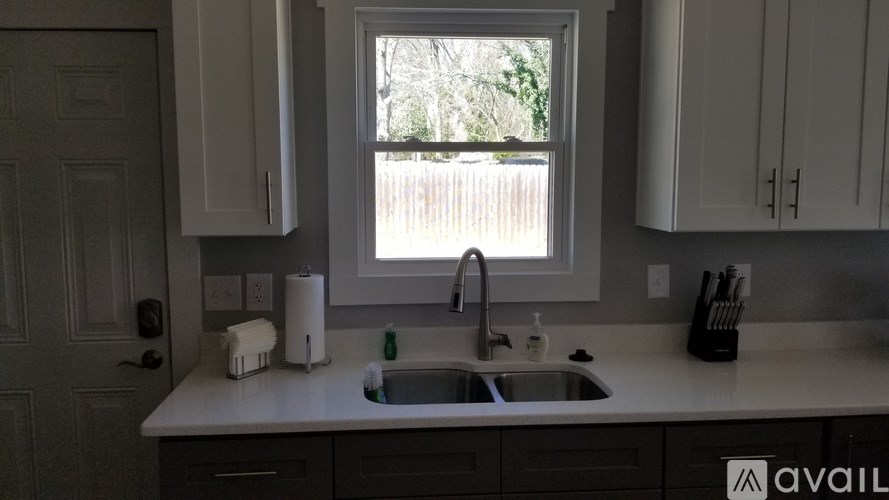 A kitchen with a sink and a window.