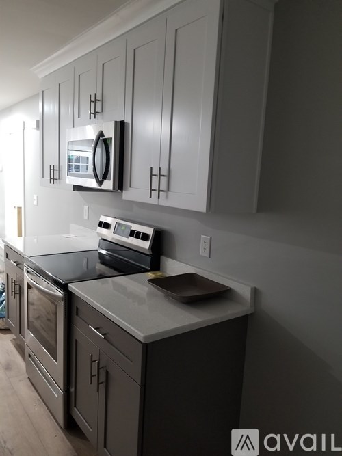 A kitchen with a stove top oven and a microwave above it.