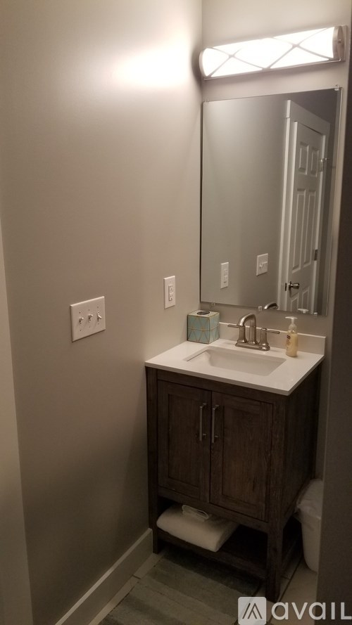 A bathroom with a sink and a mirror.