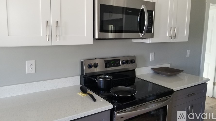 A kitchen with a stove top oven and microwave above it.