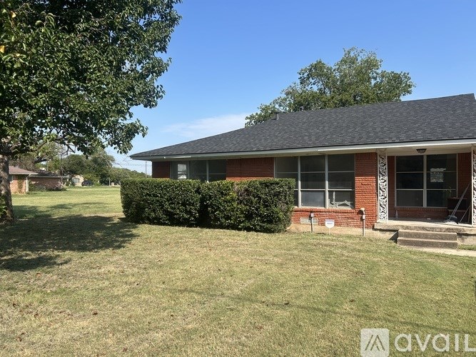 A house with a lawn in front of it.