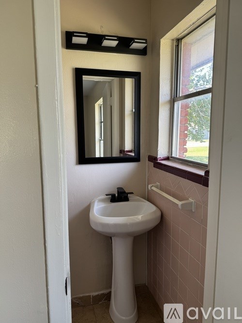 A bathroom with a sink and mirror.