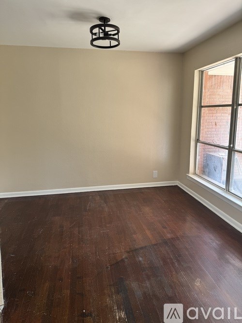 A room with wooden floors and a window.