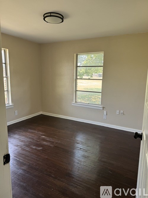A room with wooden floors and a window.