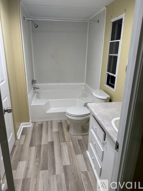 A bathroom with a toilet, sink, and bathtub.