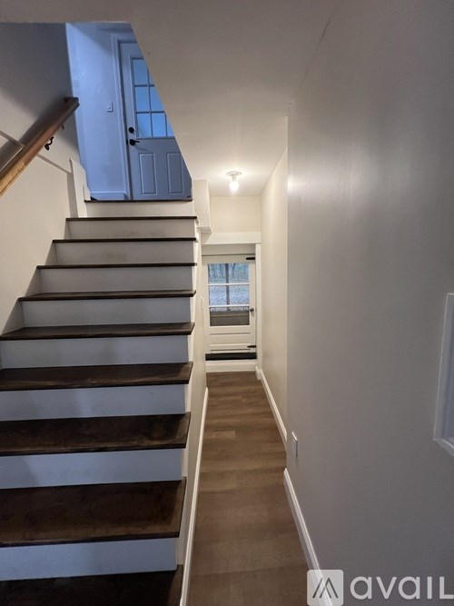 A staircase with a blue door at the top.