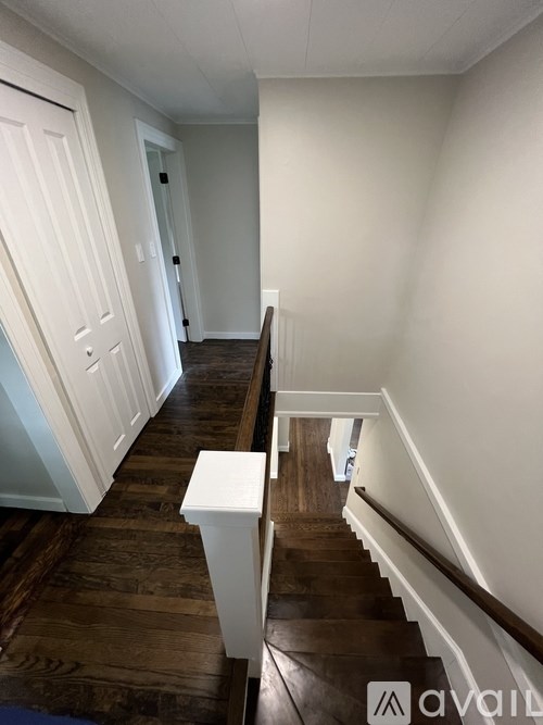 A staircase with a white railing and wooden steps.