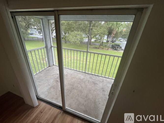 A balcony with a glass door leading to a patio.