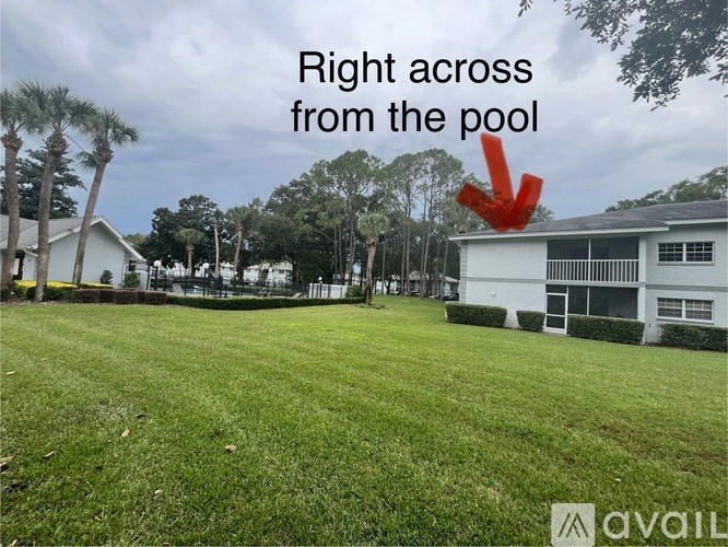 A red arrow pointing to a white building with the text "Right across from the pool" above it.