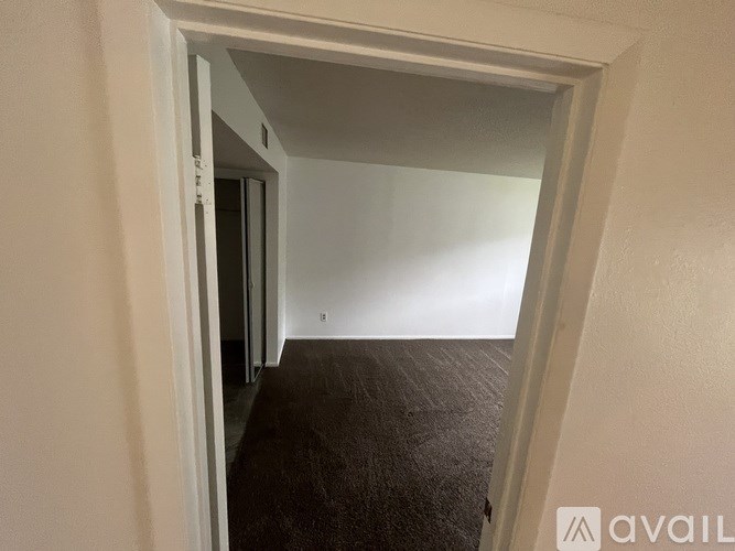 A room with a carpeted floor and white walls.