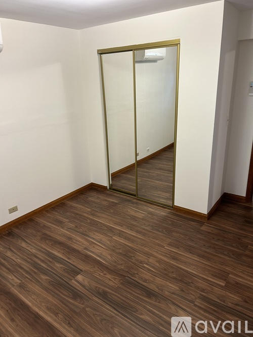 A room with a wooden floor and a glass door.