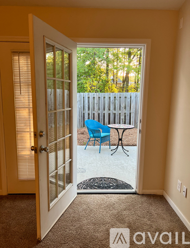 A room with a table and chairs is visible through an open door.